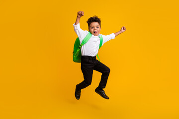 Full size photo of little funky schoolboy dressed white shirt flying raising hands up show tongue...