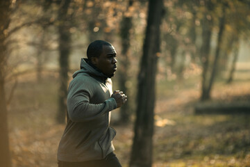Young fit man running in a outdoor park