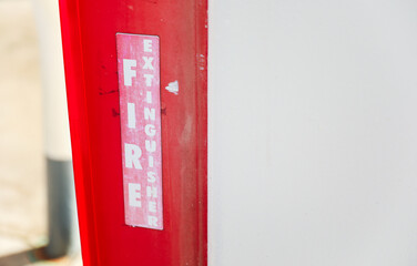 fire extinguisher against a white wall, symbolizing safety and preparedness in case of emergency, with copy space