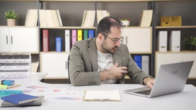 Office worker having heart attack.