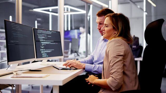 Computer Programmer Writing Program Code On Computer