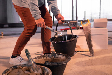 Workers work with mixed cement in construction sites.