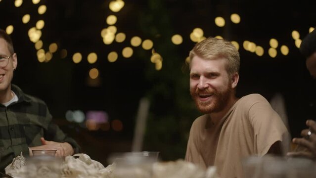 Multiethnic Young Men Dining And Chatting Cheerfully, Caucasian And African American Ethnicity