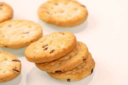 A bunch of cumin cookies lies on a white background close-up