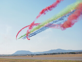 Group of fighter jet airplane with a trace of colorful smoke against sky