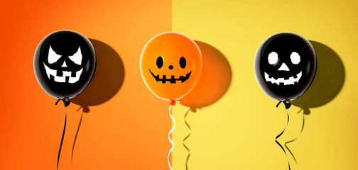 Halloween balloon ghosts with happy faces - flat lay