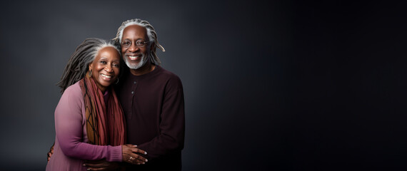 Banner Beautiful elegant mature grey haired middle aged african American couple woman and man with dreadlocks on head on black background, copyspace for text. - Powered by Adobe