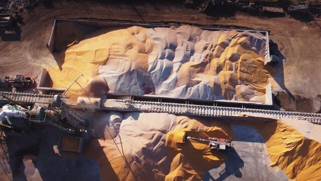 An elevator, grain drying, a tractor rolling up piles of grain, aerial photography, views from above