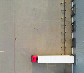 Warehouse storages or industrial factory or logistics center from above. Aerial view of industrial buildings and equipment machines. Aerial view