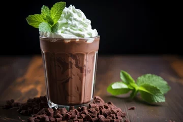 Tuinposter A refreshing close-up of an iced mint cocoa drink garnished with fresh mint leaves, topped with whipped cream and chocolate shavings © aicandy