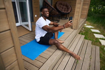 Smiling guy takes a selfie during a break between exercises