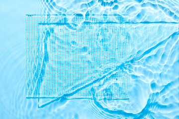 Water blue surface abstract background. Waves and ripples texture of cosmetic aqua moisturizer with bubbles and transparent ice glass inside.