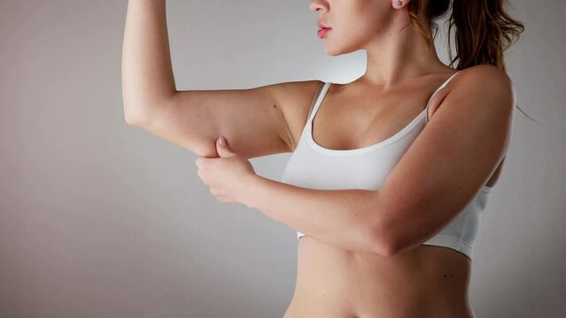 Close-up Of A Woman Holding Arm With Excess Fat