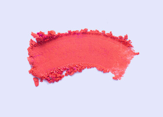 Cosmetic loose powder swatch . Eye shadow or blusher peach red natural color smudge brush stroke isolated on light blue