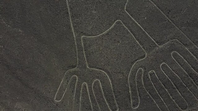 Close up view of a Geoglyph called The Frog part of the Nazca Lines geoglyphs made in the soil of the Nazca Desert Aerial video.
