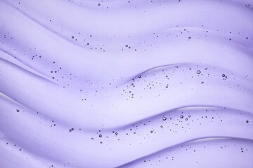 Liquid purple gel cosmetic smudge blue background