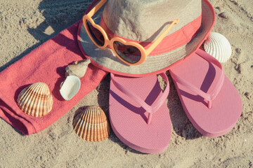 Different accessories using for relax on beach. Straw hat, flip flop, sunglasses and towel. Summertime