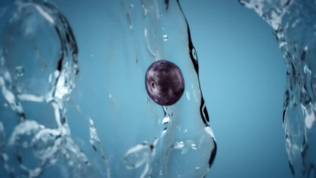 Fruit and berries tossed in the air and falling down in slow motion. Clear water splash and water droplets. Fresh blueberry fruit tossed in the air with water droplet splash falling down