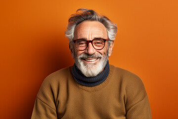 Obraz premium Portrait of an old man with glasses in the brown background