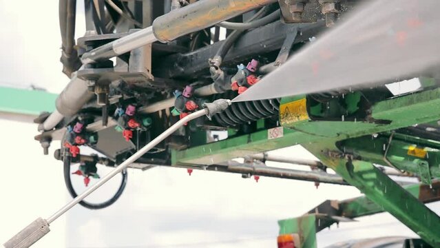 Washing of agricultural machinery with water under pressure. Washing the sprayer after working in the field. Maintenance of equipment.