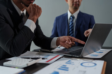 Asian business advisor meeting to analyze and discuss the situation on the financial report in the meeting room. brainstorming, discussing, and analyzing business strategy. Financial advisor concept