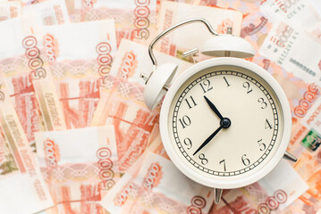 Time to pay taxes. Alarm clock and Russian banknotes. Time is money.