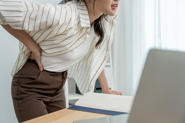 woman holding her lower back while and suffer from unbearable pain health and problems, chronic...