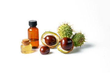 Autumn horse chestnut with peel, bottles with oil and chestnut extract on a white background - 657690960