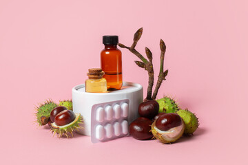 Autumn horse chestnut with peel, chestnut sprig with buds, bottles with oil and chestnut extract on a pink background - 657690998