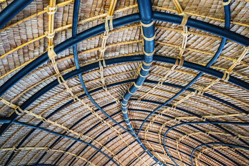 Beautiful thatched roof surface detail of mixed materials pattern structure by weave pile straw...