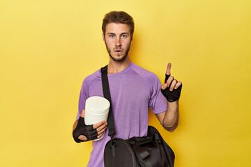 Man with protein jar and backpack on yellow having some great idea, concept of creativity.