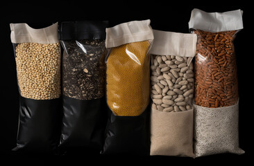 Heap of different cereals, grains, groats, legumes and beans isolated on black background
