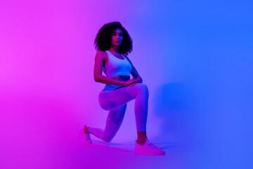 Full length profile portrait of slender fitness blogger stretch leg lunges trendy outfit ad isolated on blue pink color neon background