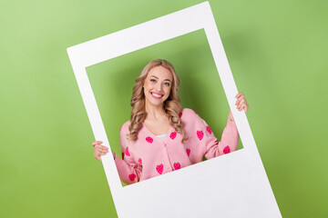 Photo of young charming lady blonde curly hair hold paper cadre frame capture memories her birthday...