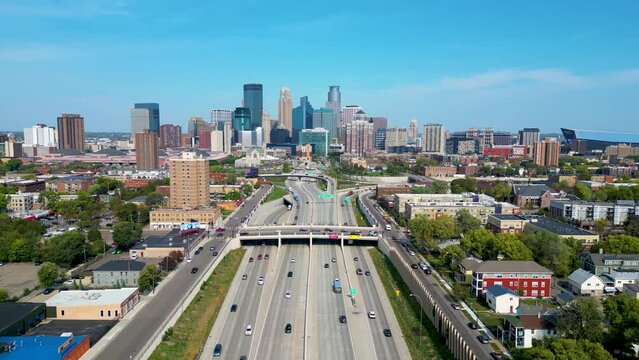 Minneapolis Downtown Skyline with a flowing vehicle traffic on a freeway