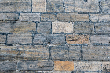 Close-up view of a wall made of stones, irregular shapes
