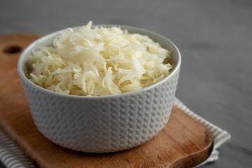 Homemade German Sauerkraut in a Bowl on a gray background, side view.