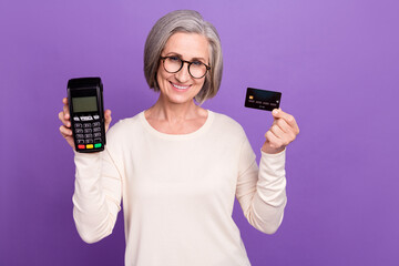 Photo of commerce director senior woman hold terminal transfer finance between customer client business isolated on purple color background