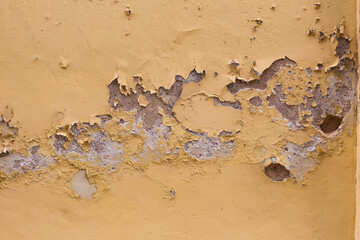 old cracked wall and peeling paint with cracks