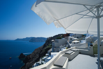 Apartment balcony in a white luxurious resort with great views of the Santorini Island shore...