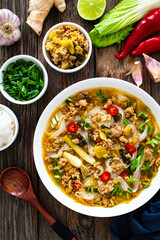 Yunnan rice noodle soup on wooden table