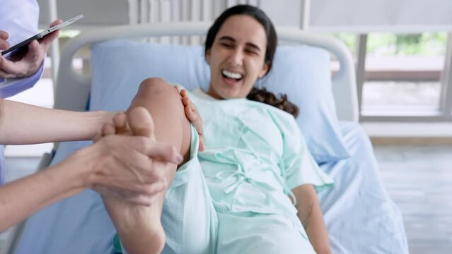 Hispanic woman's face in pain, lying in bed to do physical therapy physical therapist Medical assistant, orthopedic specialist Testing leg lifts To check the joints of the leg bones and knees