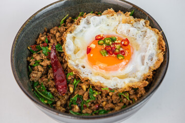 Kaprao pork with fried egg. Thai basil stir fried with pork. Thai street food. Isolated
