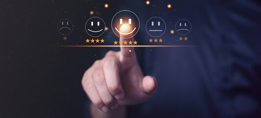 Businessman pressing smiley face emoticon on virtual touch screen. Customer service evaluation...