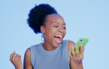 Celebration. phone and young black woman in a studio with winning, achievement or success. Happy,...
