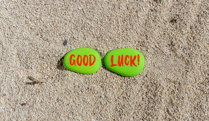 Fototapeta na wymiar Good luck symbol. Concept words Good luck on beautiful green stone. Beautiful sea sand beach background. Business, motivational good luck concept. Copy space.