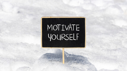 Motivate yourself symbol. Concept words Motivate yourself on beautiful black chalk blackboard. Chalkboard. Beautiful snow background. Business psychology motivate yourself concept. Copy space.