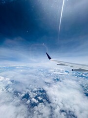where clouds dance and horizons stretch into infinity, from the soaring perspective of an airplane.