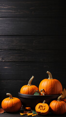 pumpkin over black wooden table background. Backdrop with copy space 