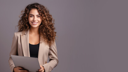 Smiling curly brunette businesswoman holding laptop computer
